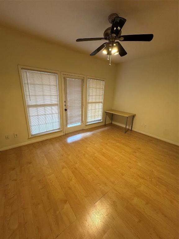 unfurnished room featuring ceiling fan and light wood-type flooring