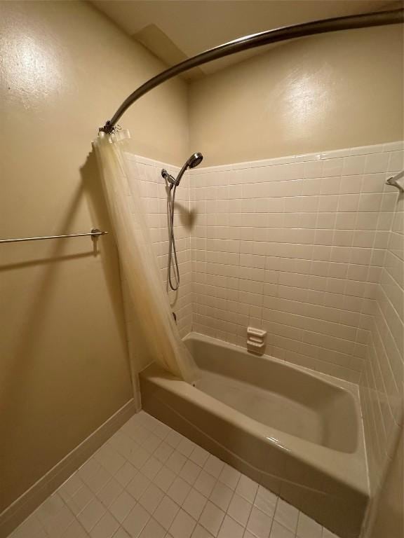 bathroom with shower / bathtub combination with curtain and tile patterned flooring