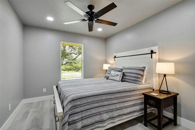 bedroom featuring light hardwood / wood-style floors and ceiling fan