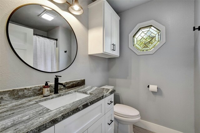 bathroom with vanity and toilet