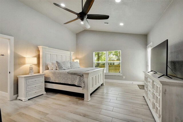 bedroom featuring ceiling fan, vaulted ceiling, and light hardwood / wood-style flooring