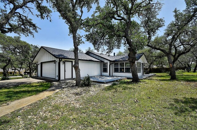 ranch-style house featuring a garage and a front yard