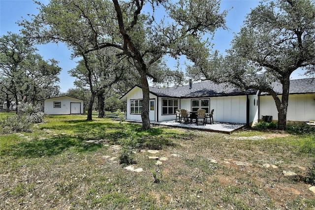 rear view of house with a yard and a patio area