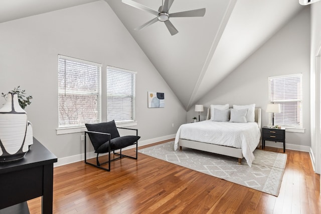 bedroom with hardwood / wood-style floors, vaulted ceiling, and ceiling fan