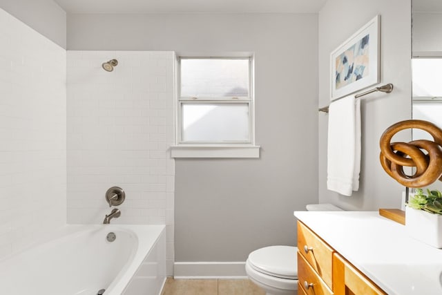 full bathroom with vanity, tiled shower / bath, tile patterned floors, and toilet