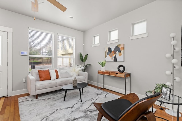 living room with ceiling fan and light wood-type flooring