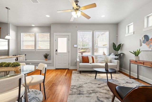 interior space with ceiling fan, a healthy amount of sunlight, and light wood-type flooring