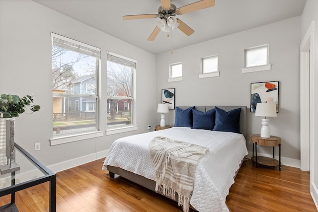 bedroom with wood-type flooring and ceiling fan