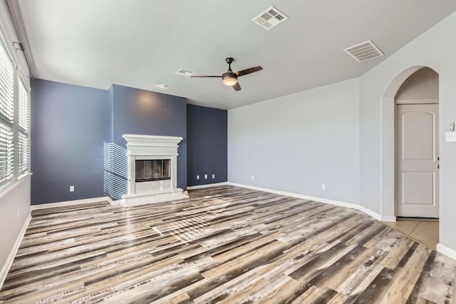 unfurnished living room with light hardwood / wood-style flooring and ceiling fan