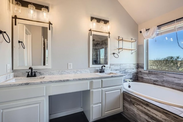 bathroom with vanity, lofted ceiling, and shower with separate bathtub