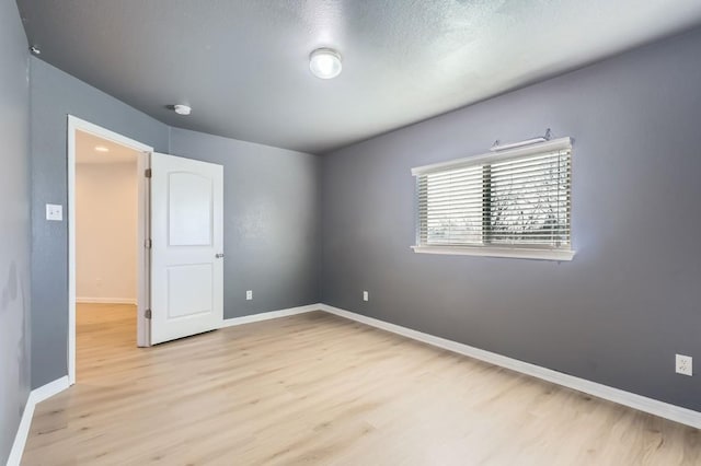 unfurnished bedroom featuring a textured ceiling and light wood-type flooring