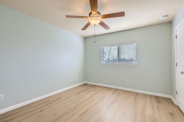 spare room with ceiling fan and light wood-type flooring