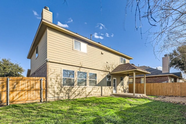 rear view of property with a lawn