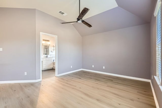 unfurnished bedroom with vaulted ceiling, light hardwood / wood-style floors, ceiling fan, and ensuite bathroom