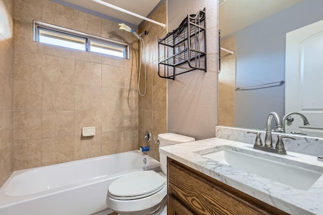 full bathroom featuring vanity, toilet, and tiled shower / bath