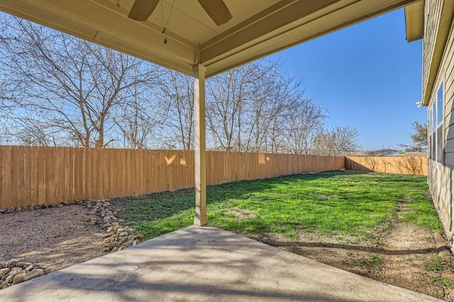 view of yard with a patio and ceiling fan