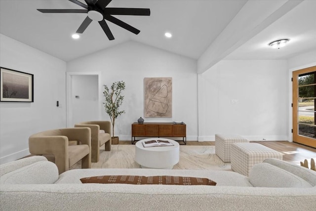 living room featuring vaulted ceiling, light hardwood / wood-style floors, and ceiling fan