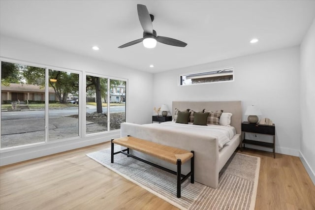 bedroom with ceiling fan and light hardwood / wood-style flooring