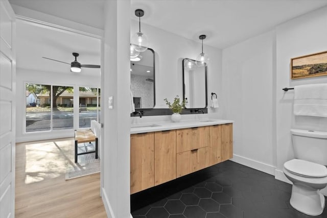 bathroom with ceiling fan, vanity, toilet, and tile patterned flooring