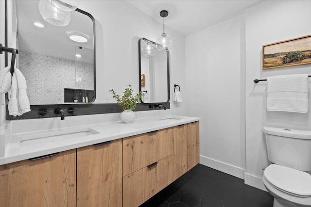 bathroom featuring tile patterned flooring, vanity, and toilet