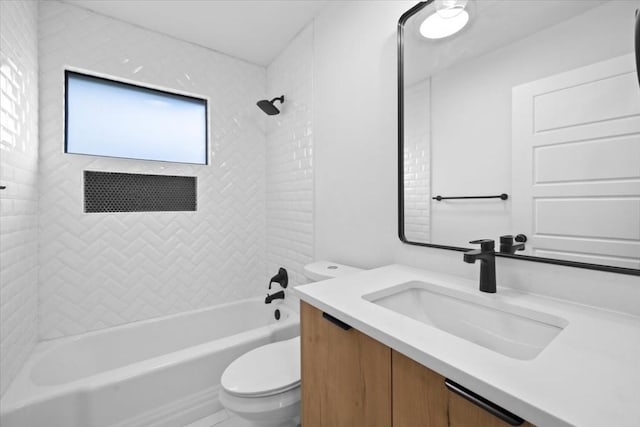 full bathroom featuring vanity, toilet, and tiled shower / bath combo