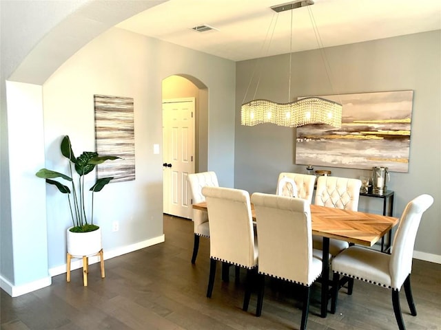 dining area with dark hardwood / wood-style flooring