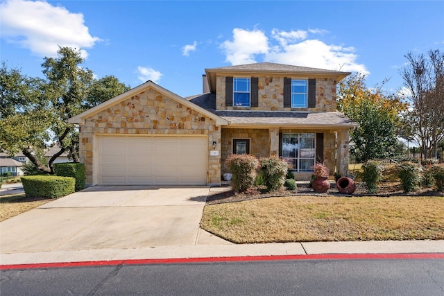 view of property featuring a garage and a front yard