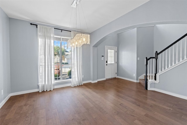 foyer entrance with hardwood / wood-style flooring and a chandelier