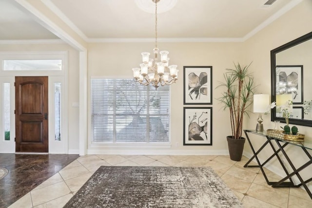 tiled foyer entrance featuring crown molding and a chandelier