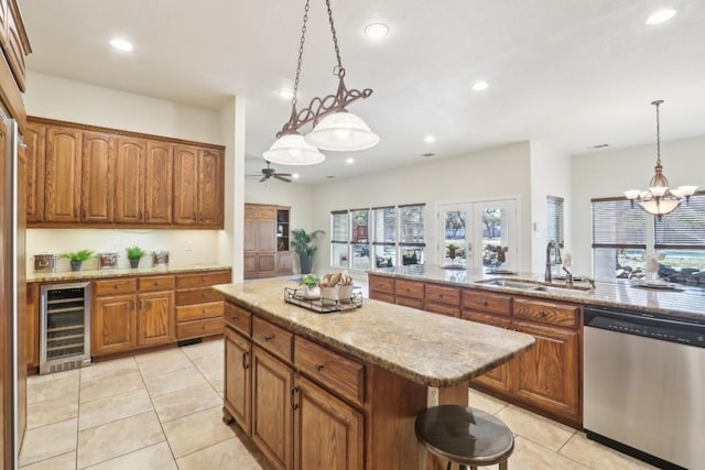 kitchen featuring a center island, a sink, wine cooler, brown cabinets, and stainless steel dishwasher