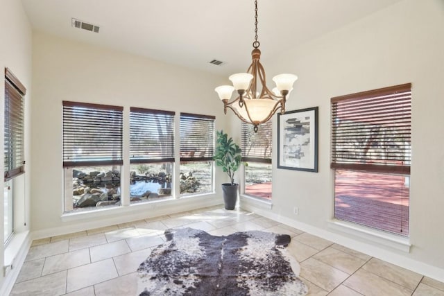 tiled dining space with a notable chandelier