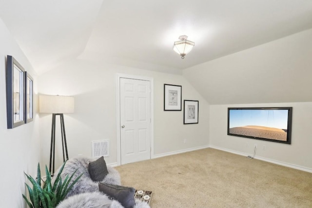 interior space featuring lofted ceiling, visible vents, baseboards, and carpet floors