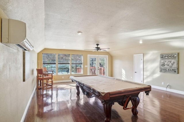 game room with lofted ceiling, hardwood / wood-style flooring, and a textured ceiling