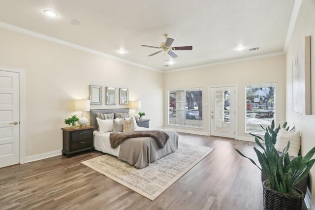 bedroom with access to outside, crown molding, visible vents, wood finished floors, and baseboards