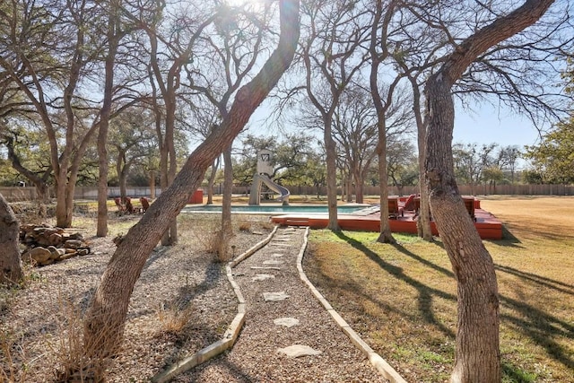 surrounding community featuring a swimming pool and a lawn