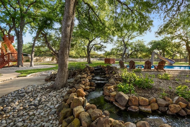 exterior space featuring a pool and fence