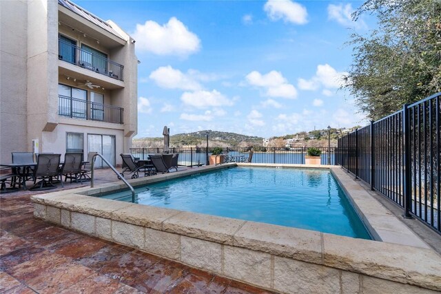 view of swimming pool with a fenced in pool, a patio area, outdoor dining area, and fence