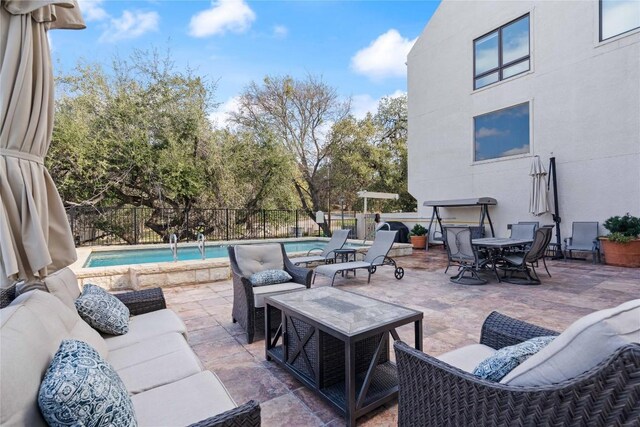 view of patio / terrace featuring an outdoor living space, outdoor dining area, a fenced in pool, and fence