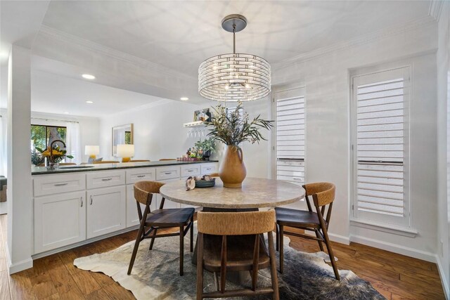 dining area featuring a notable chandelier, dark wood-type flooring, and crown molding