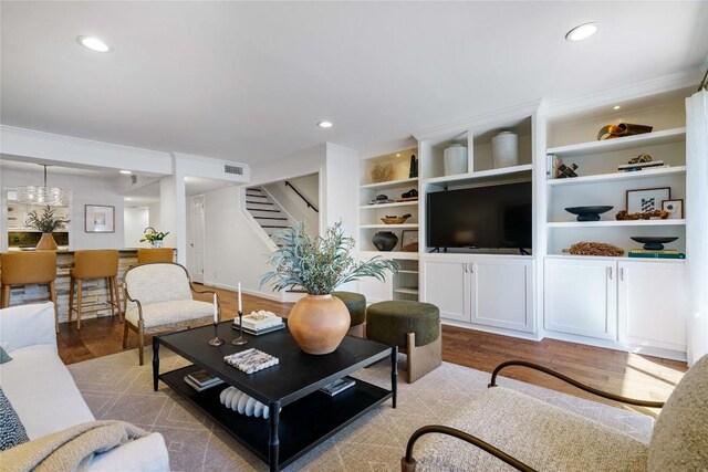 living room featuring recessed lighting, stairway, visible vents, and wood finished floors