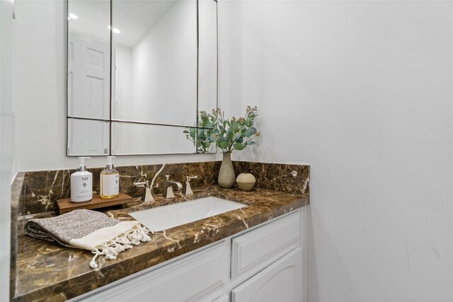 bathroom with recessed lighting and vanity