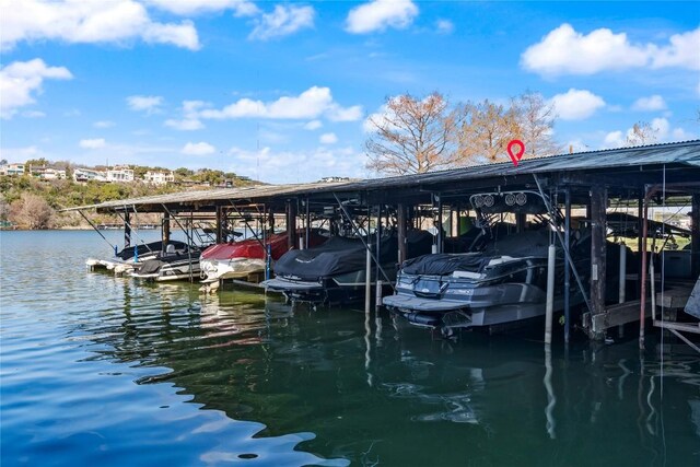 dock area with a water view and boat lift