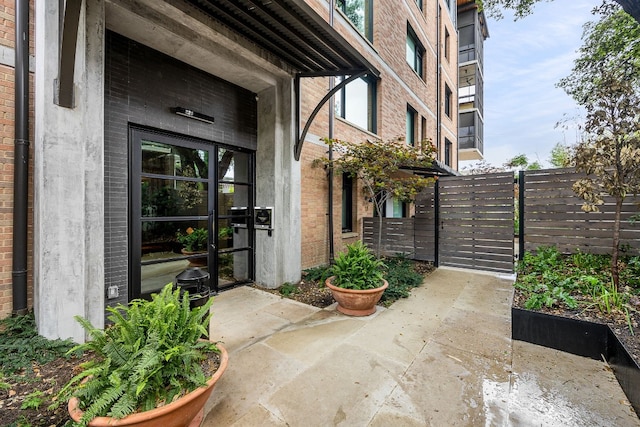 view of exterior entry featuring a patio area