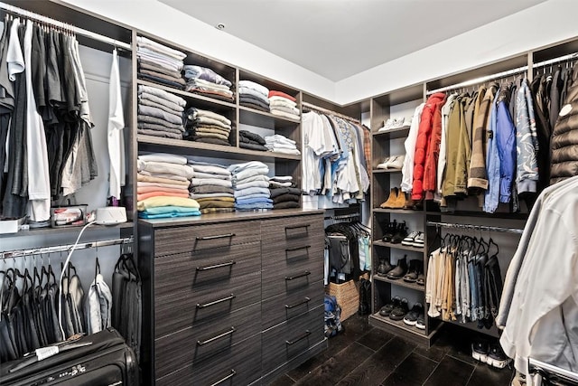 walk in closet with dark hardwood / wood-style flooring