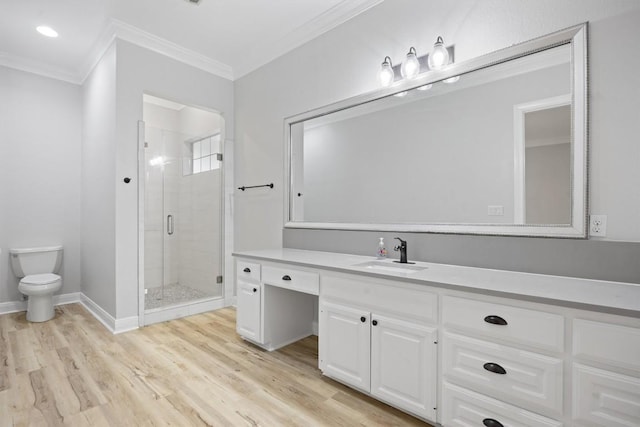 bathroom with crown molding, vanity, wood-type flooring, a shower with shower door, and toilet