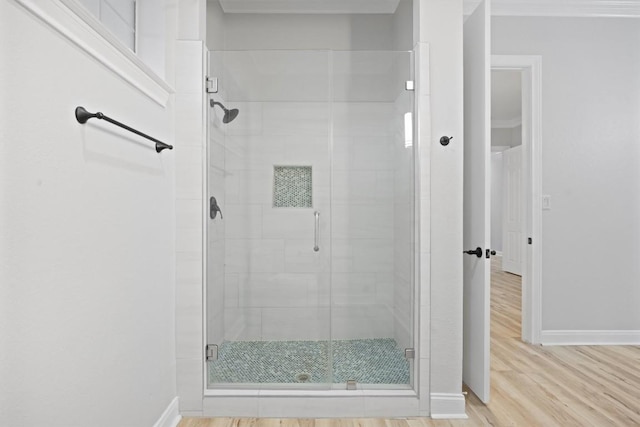 bathroom featuring hardwood / wood-style floors and an enclosed shower