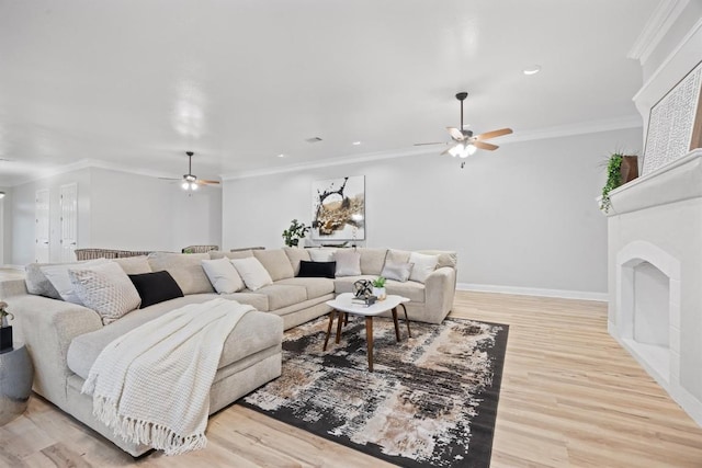 living room with ornamental molding, ceiling fan, and light hardwood / wood-style floors