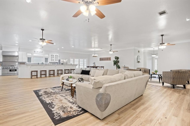 living room with light hardwood / wood-style flooring and ornamental molding