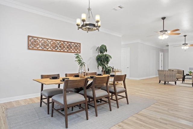 dining room featuring ornamental molding, light hardwood / wood-style flooring, and a notable chandelier