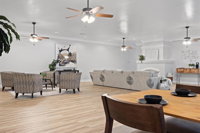 living room featuring ornamental molding and light hardwood / wood-style flooring